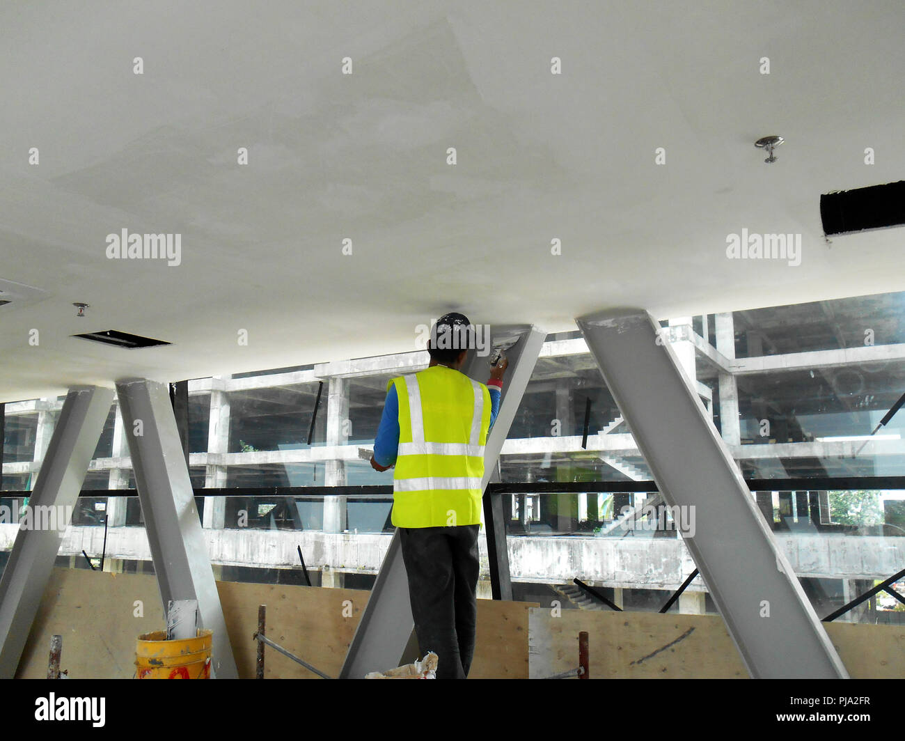 Construction Site Workers Are Doing Ceiling Soffit Skim Coat