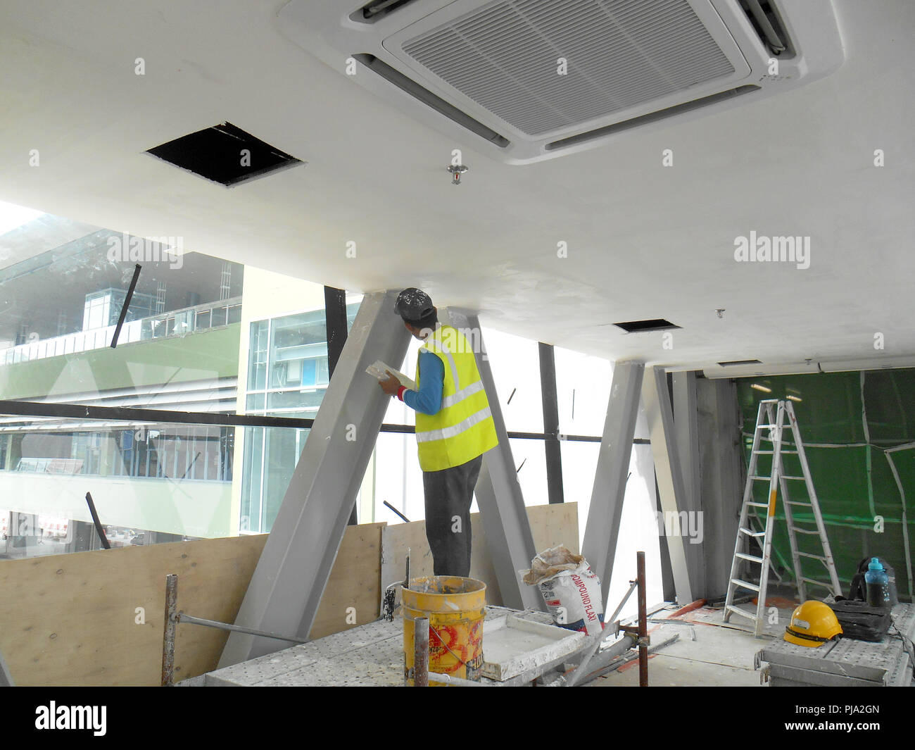 Construction Site Workers Are Doing Ceiling Soffit Skim Coat