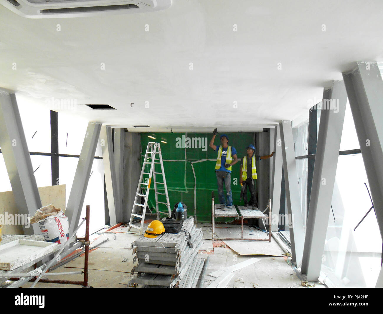 Construction Site Workers Are Doing Ceiling Soffit Skim Coat