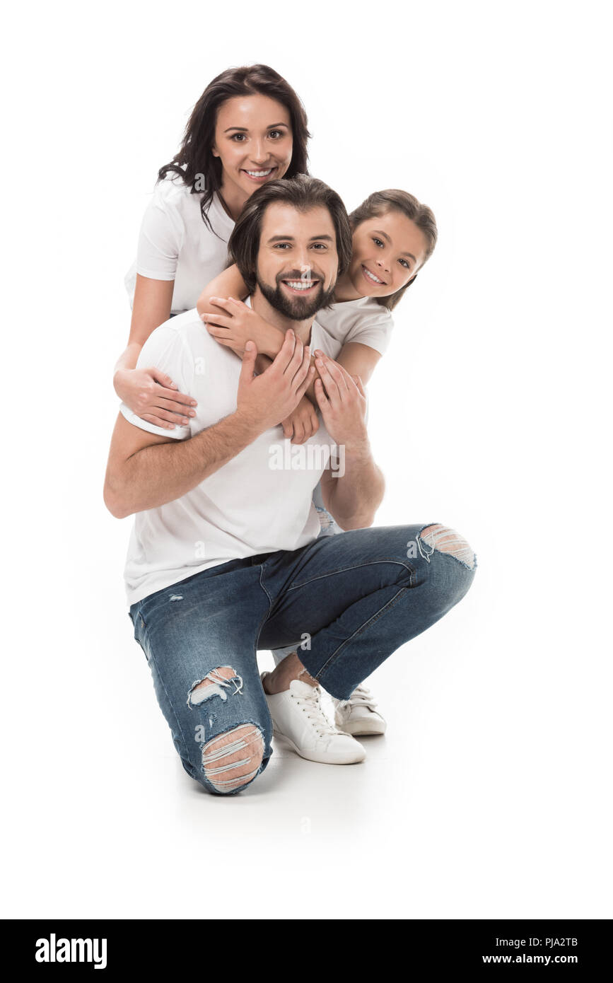 happy family in white shirts and jeans looking at camera isolated on