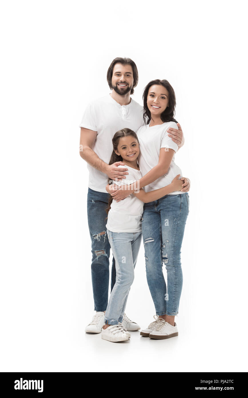 happy family in white shirts and jeans looking at camera isolated on