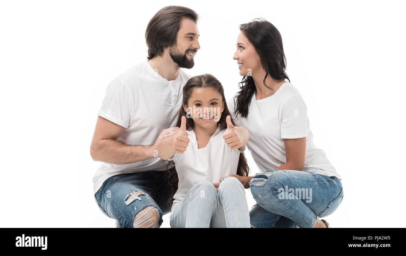 portrait of smiling kid showing thumbs up with parents behind isolated ...
