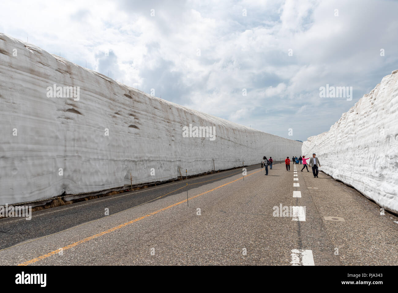TOYAMA , JAPAN - MAY 28, 2018 : People are walking at Tateyama Kurobe Alpine Route the snow mountains wall at Kurobe alpine. Toyama city, Japan. Stock Photo