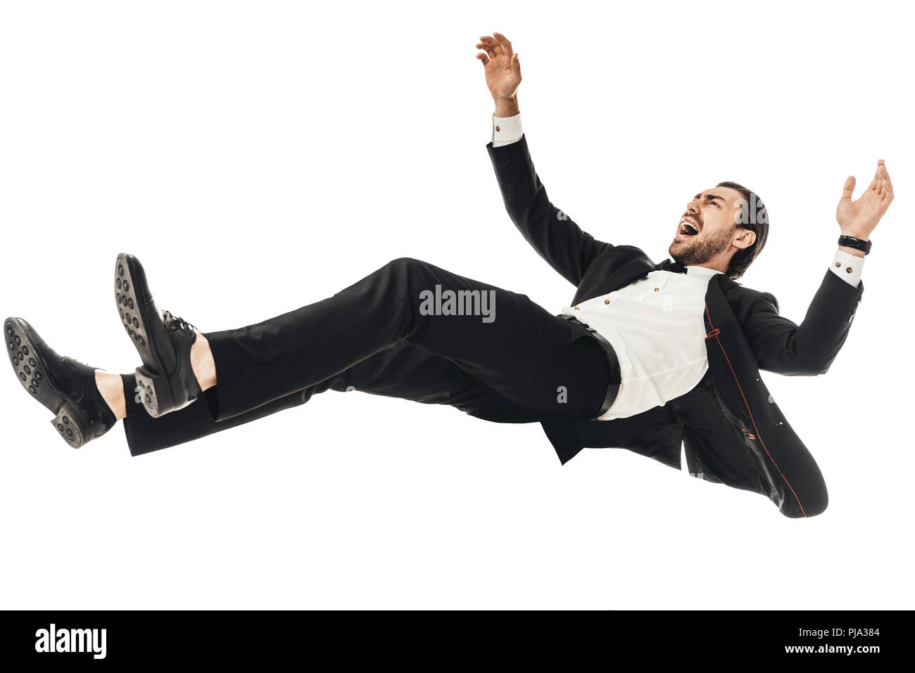 scared young businessman in suit falling isolated on white Stock Photo