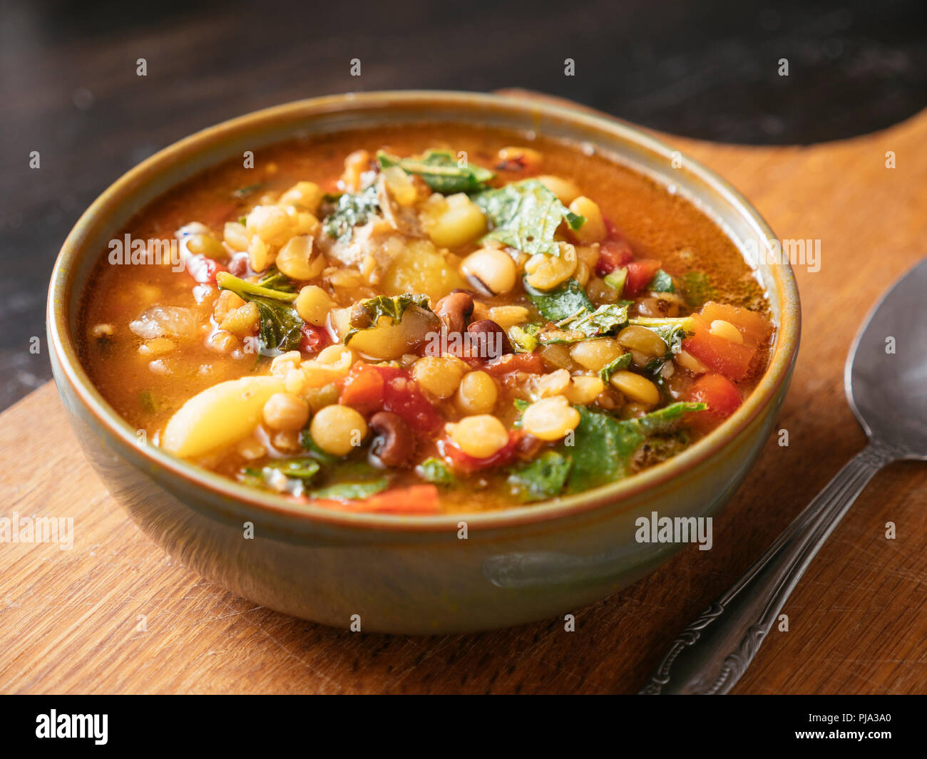 Bowl with a 5 bean soup with turnip greens. Stock Photo