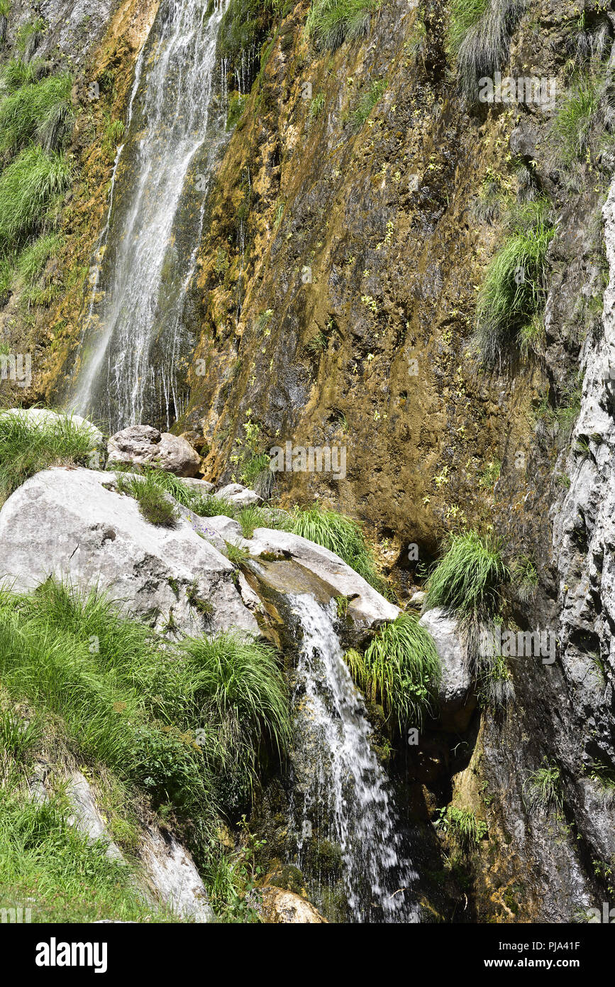 Waterfall tumbling down from Cueto Redondo by the path leading from Cain de Arriba to Sedo Mesones and Mesones in the Picos de Europa, northern Spain. Stock Photo