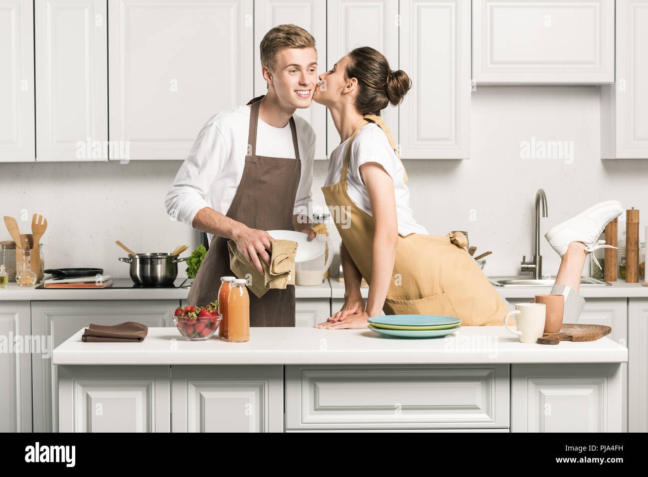 https://c8.alamy.com/comp/PJA4FH/girlfriend-kissing-boyfriend-for-drying-dishes-in-kitchen-PJA4FH.jpg