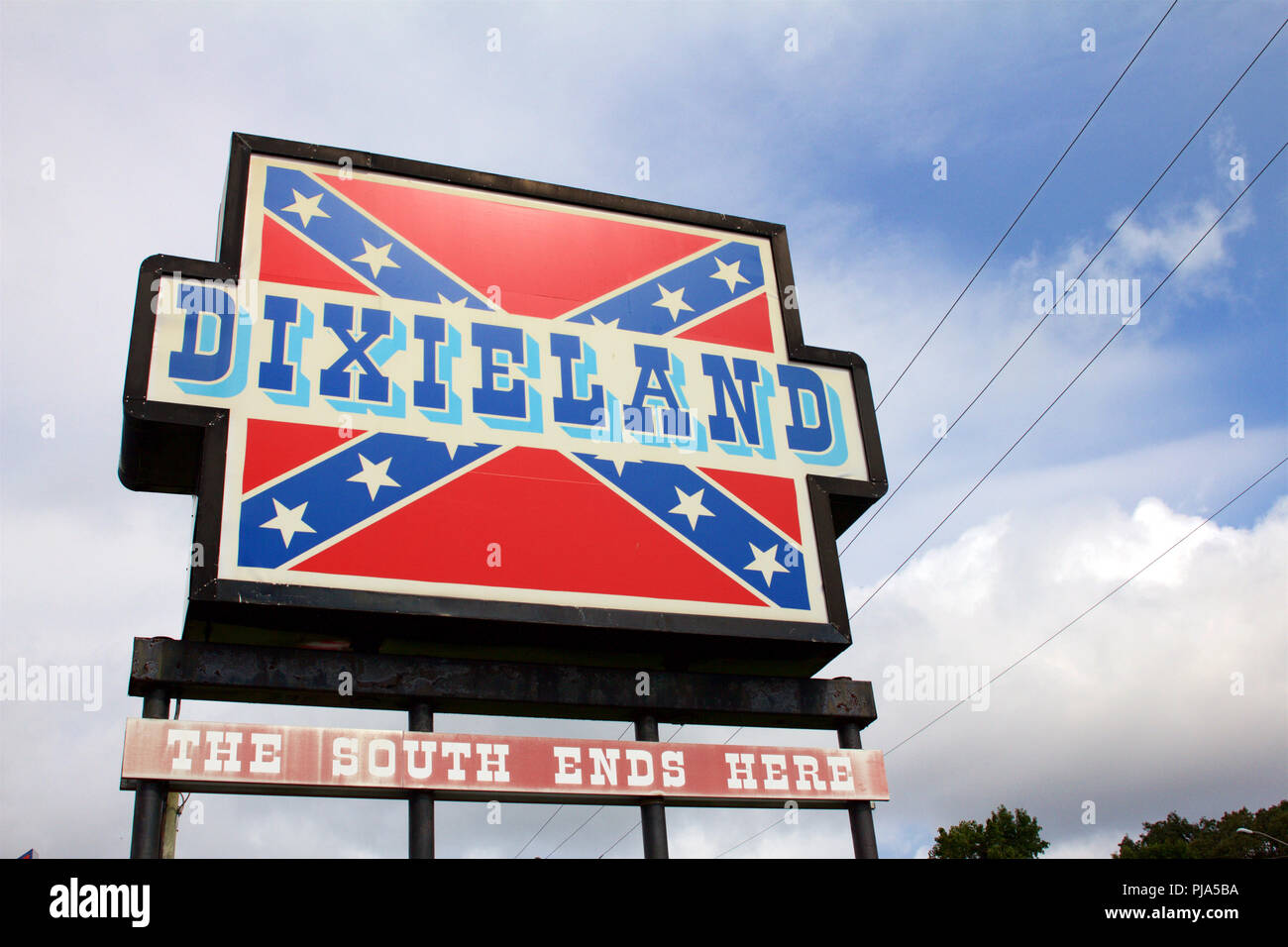 New Church, Virginia, USA - September 1, 2018: Confederate flags surpass American flags in size and number at Dixieland, a gas station and gift shop. Stock Photo