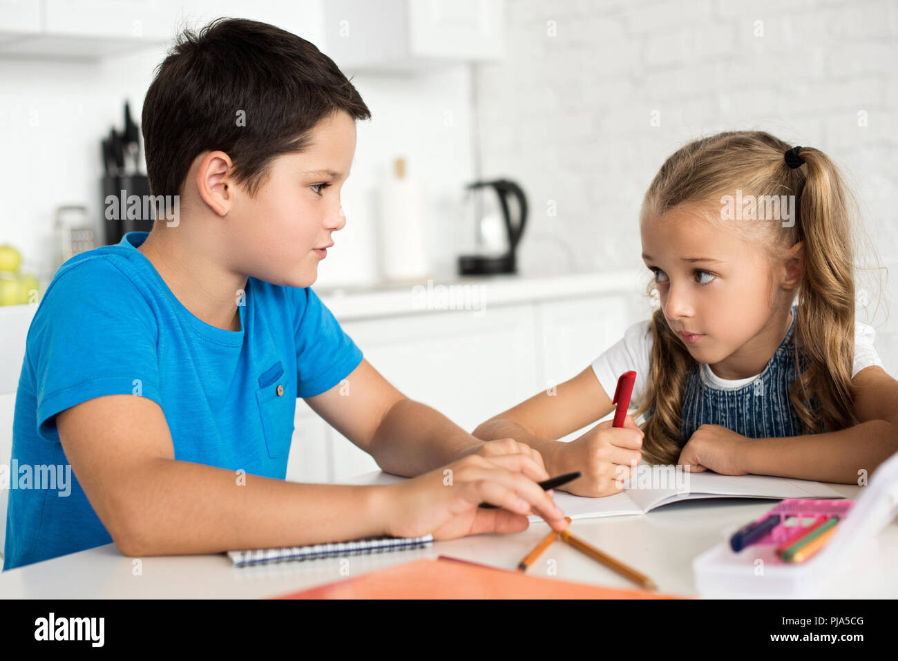 brother and sister doing homework together