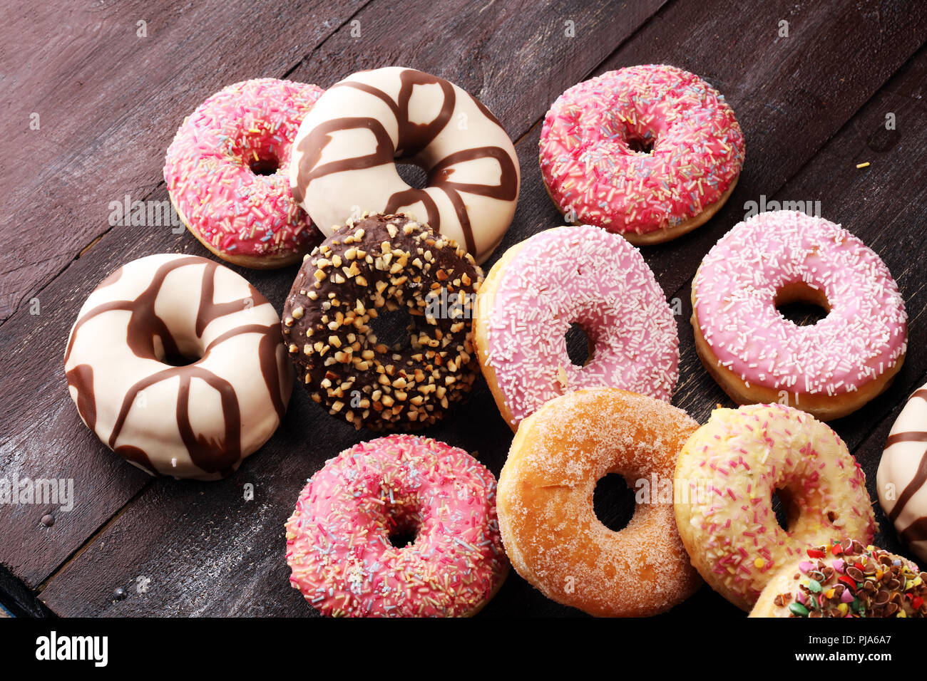 assorted donuts with chocolate frosted, pink glazed and sprinkles ...