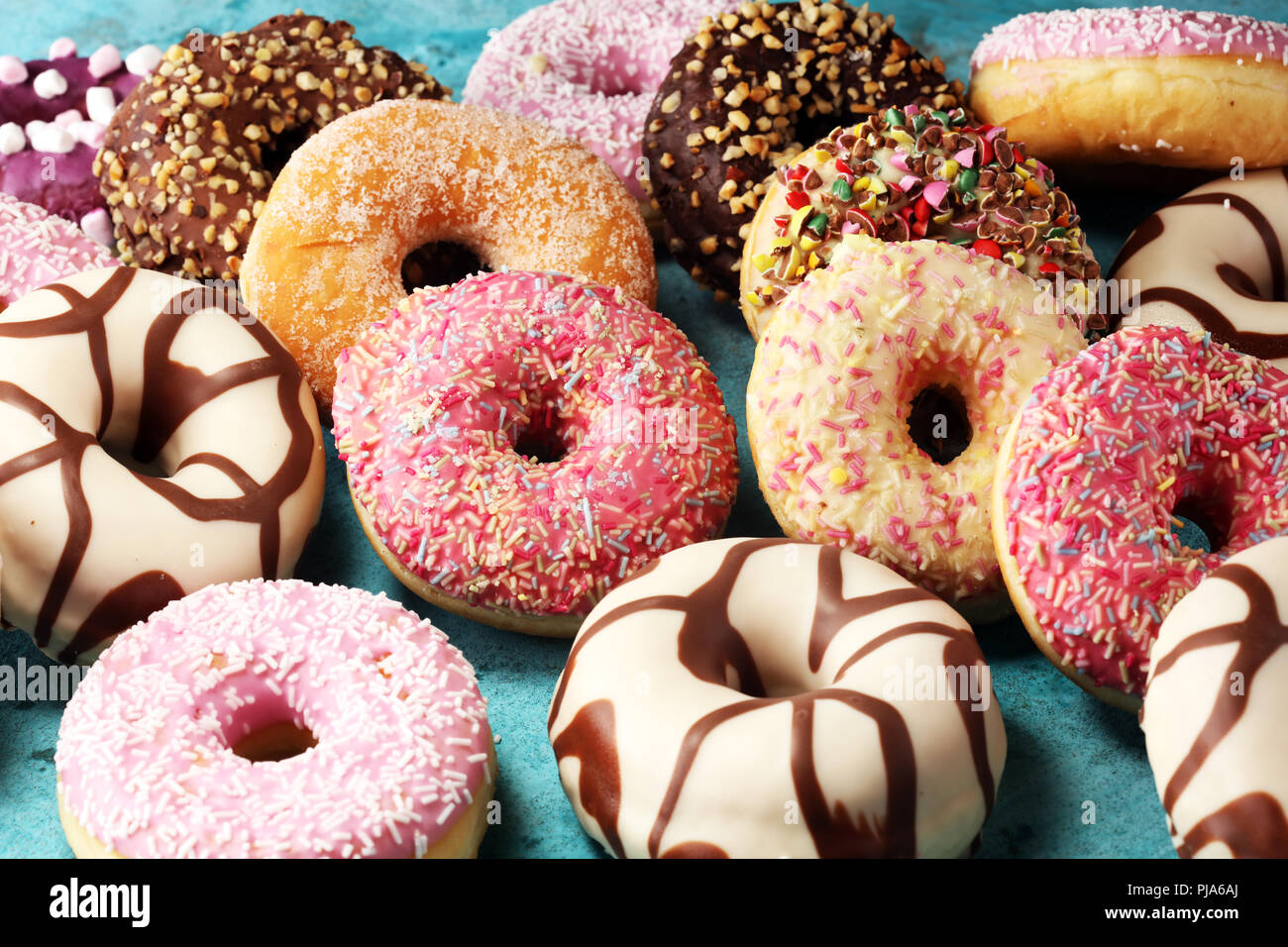 assorted donuts with chocolate frosted, pink glazed and sprinkles ...