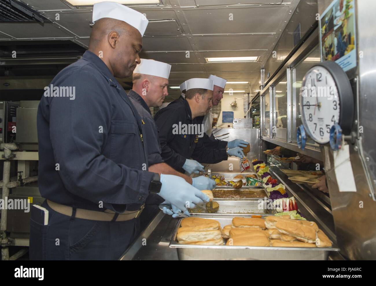 PACIFIC OCEAN (July 4, 2018) Left to right, Lt. Cmdr. Robert Kersey, Lt.  Mark Wilkinson, Capt. Larry McCullen, commanding officer of the amphibious  assault ship USS Bonhomme Richard (LHD 6), and Lt.