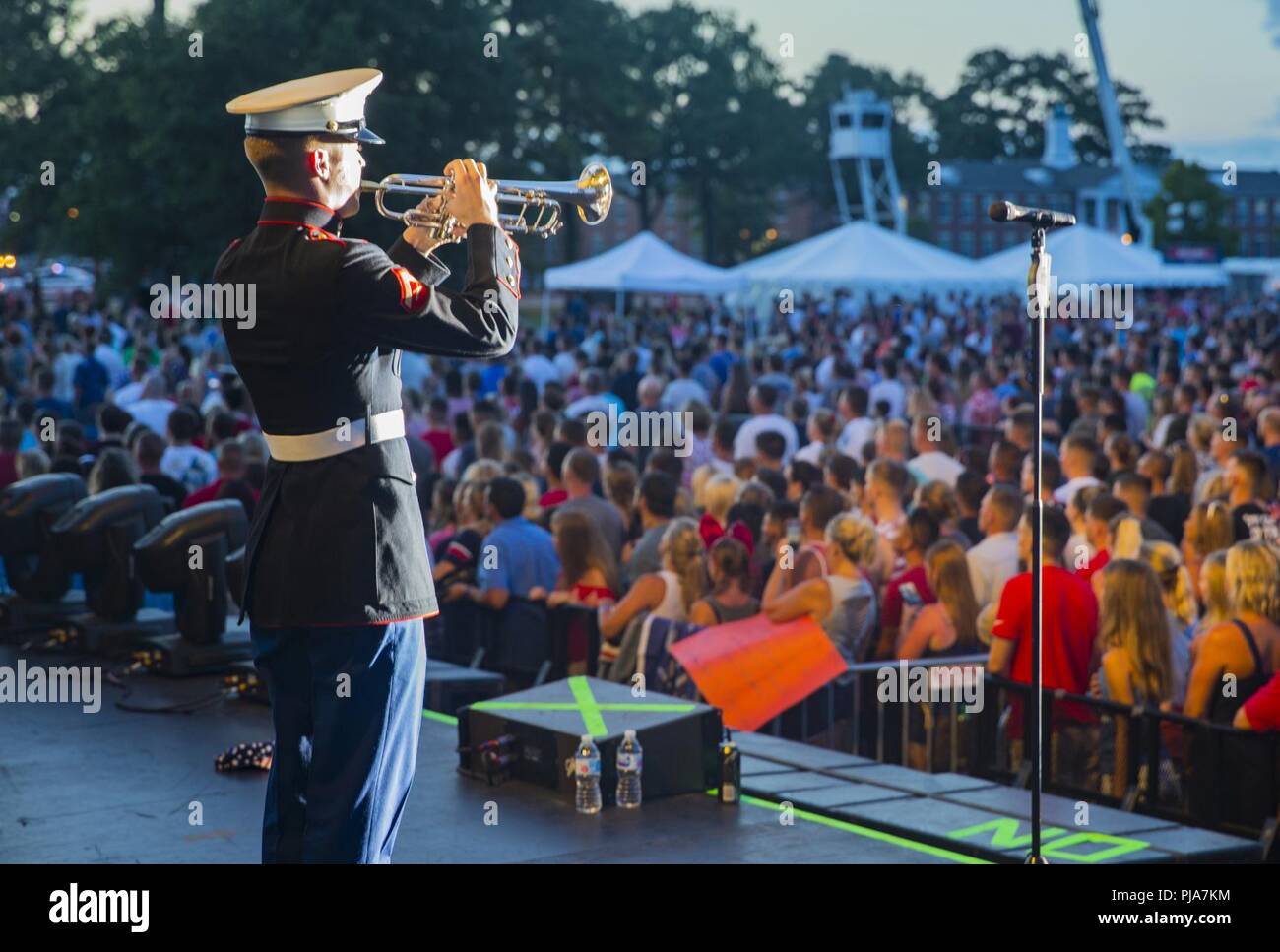 Marines, Sailors, and civilians attend Marine Corps Base Camp Lejeune’s annual fourth of July celebration at William Pendleton Thomas Field on MCB Camp Lejeune, N.C., July 4, 2018. From 1776 to present day, July fourth has been adopted as the birth of American Independence, later on becoming a national holiday in 1870 by Congress. This year also marks the 77th anniversary of Camp Lejeune. Stock Photo