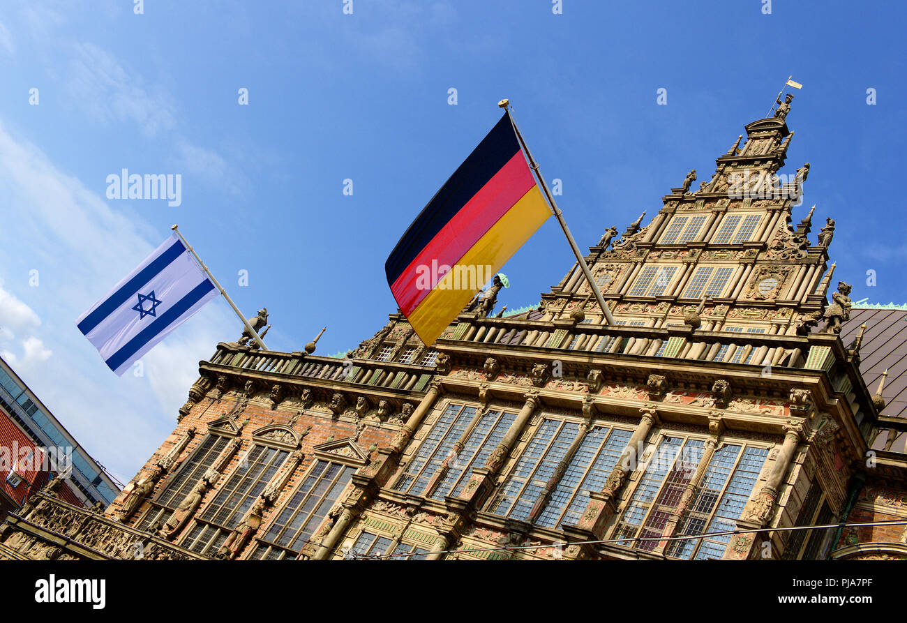 Bremen, Germany - Israeli and German flags flying from the historic city hall in honor of the first visit of Israel's ambassador to Germany Stock Photo