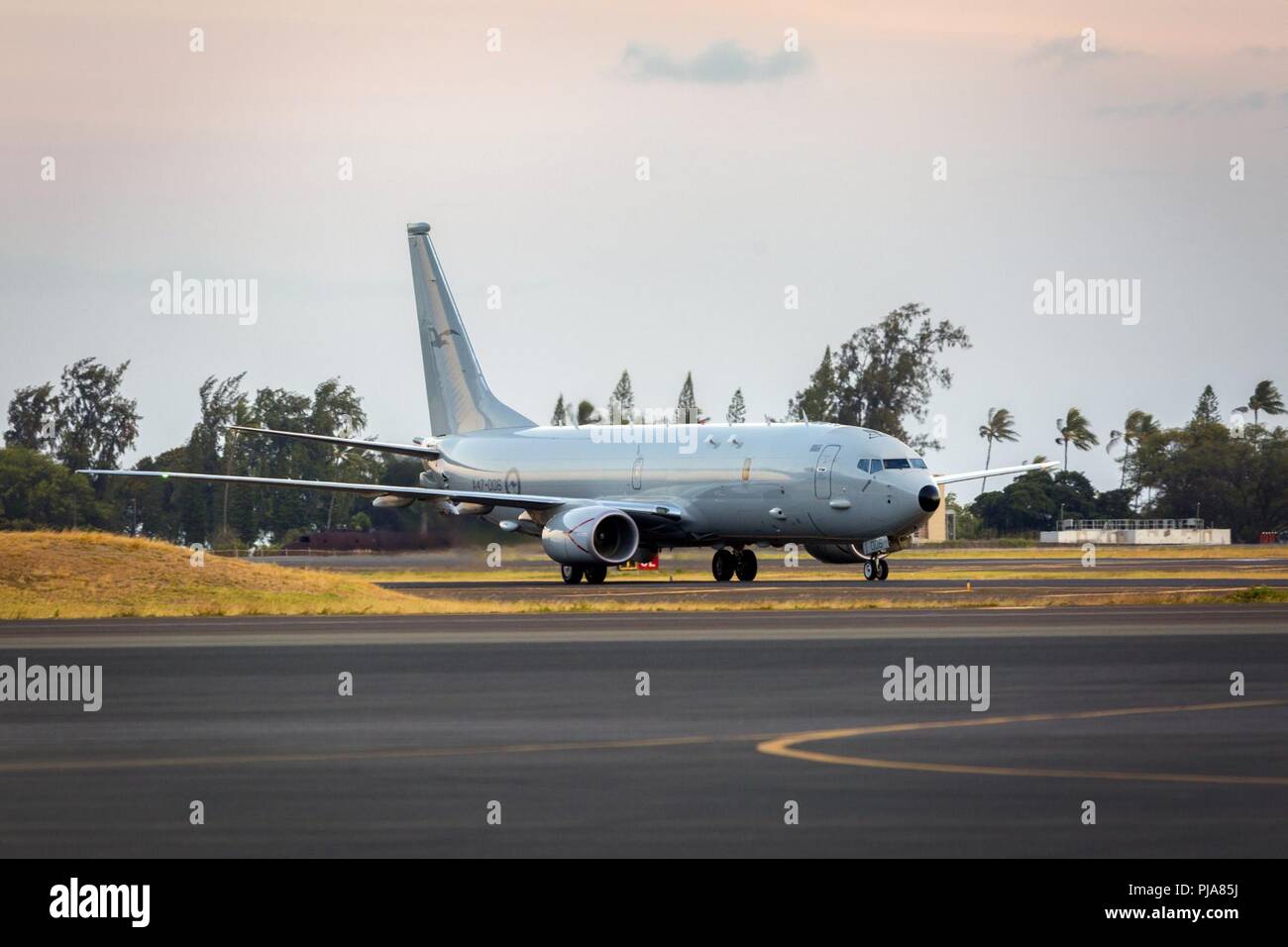 Pearl Harbor (July 3, 2018) A Royal Australian Air Force P-8A Poseidon aircraft taxis in to Joint Base Pearl Harbor–Hickam during Exercise Rim of the Pacific (RIMPAC), July 3.  Twenty-five nations, 46 ships, five submarines, about 200 aircraft, and 25,000 personnel are participating in RIMPAC from June 27 to Aug. 2 in and around the Hawaiian Islands and Southern California. The world’s largest international maritime exercise, RIMPAC provides a unique training opportunity while fostering and sustaining cooperative relationships among participants critical to ensuring the safety of sea lanes and Stock Photo