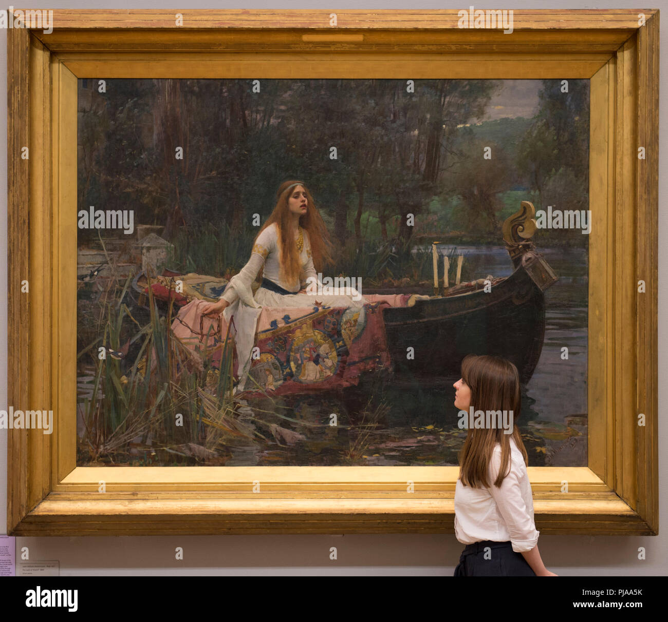 Tate Britain, London, UK. 5 September, 2018. Tate Britain staff with John William Waterhouse’s The Lady of Shalott 1888 to mark the launch of a major new exhibition at the National Gallery of Australia. Over forty works from Tate Britain’s collection of Pre-Raphaelite art will be loaned to the National Gallery of Australia in December for a major new exhibition. Credit: Malcolm Park/Alamy Live News. Stock Photo
