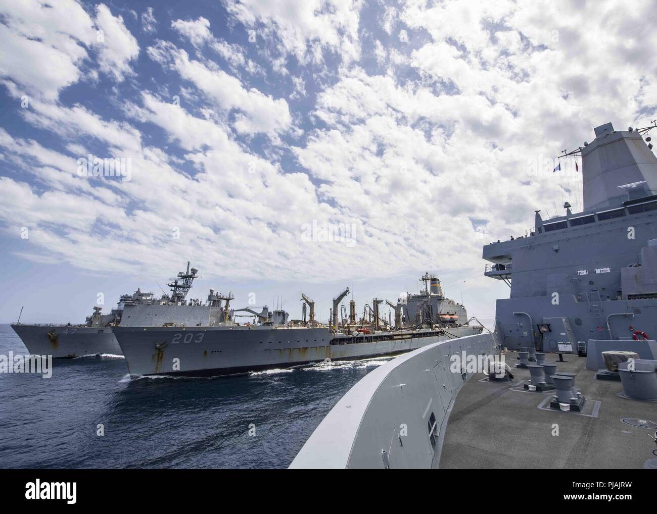 Gulf Of Aden. 4th Sep, 2018. GULF OF ADEN (Sept. 4, 2018) The San Antonio-class amphibious transport dock ship USS Anchorage (LPD 23), right, conducts a replenishment-at-sea with the Whidbey Island-class amphibious dock landing ship USS Rushmore (LSD 47) and the fleet replenishment oiler USNS Laramie (T-AO 203) during a scheduled deployment of the Essex Amphibious Ready Group (ARG) and the 13th Marine Expeditionary Unit (MEU). The Essex ARG/13th MEU is a lethal, flexible, and persistent Navy-Marine Corps team deployed to the U.S. 5th Fleet area of operations in support of naval operation Stock Photo
