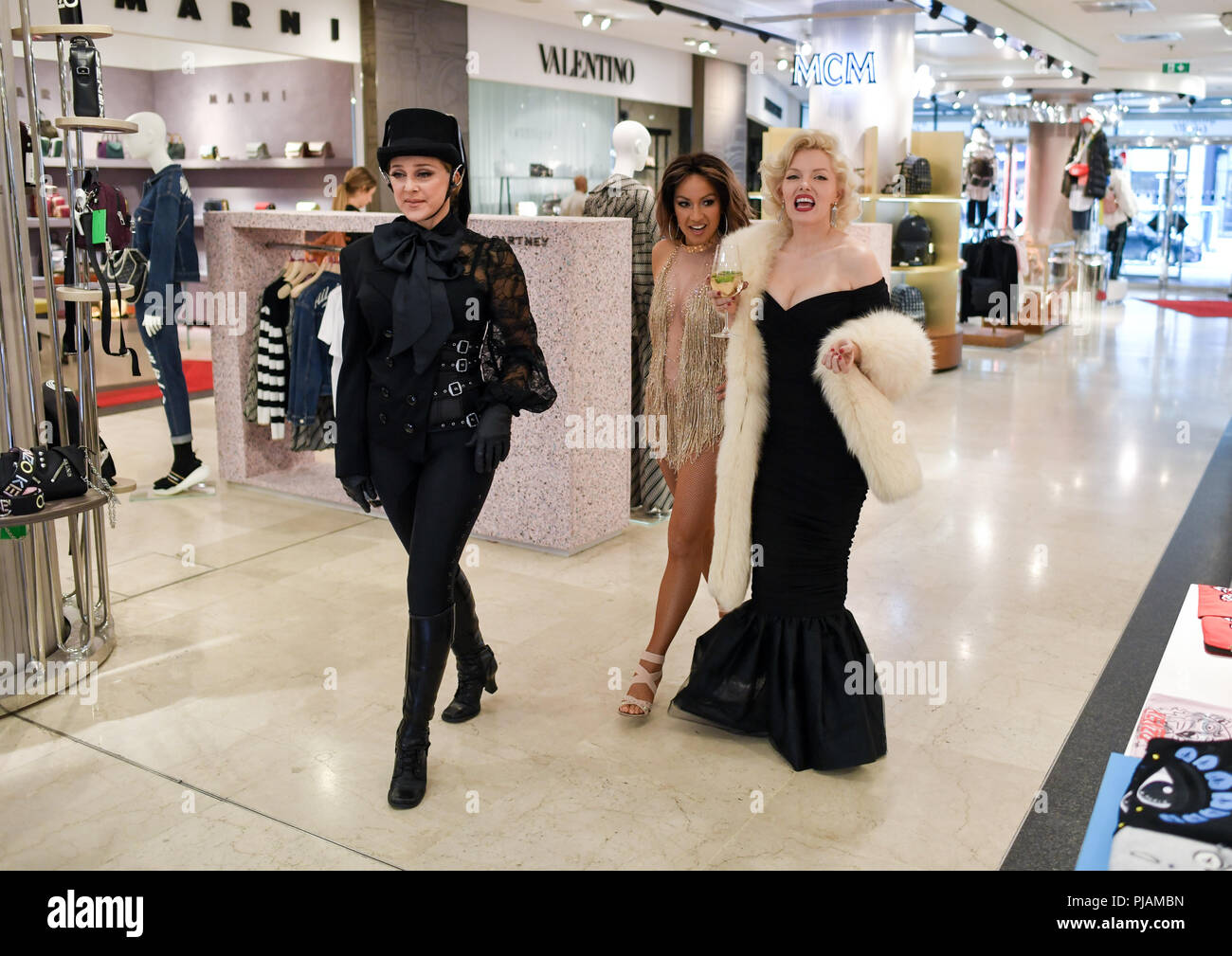 Berlin, Germany. 6th September, 2018. The doppelganger of Madonna (l-r),  Jennifer Lopez and Marilyn Monroe from the show "DIVAS - The Show" visit the  luxury department store Galeries Lafayette on the occasion