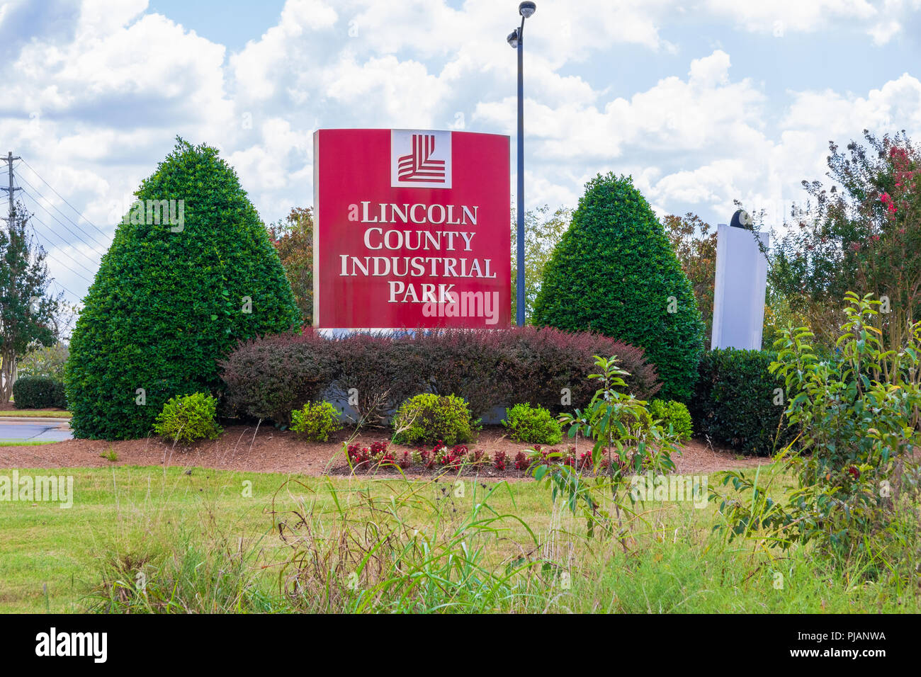 LINCOLNTON, NC, USA-9/2/18:  Sign and logo framed by shrubbery  for the Lincoln County Industrial Park. Stock Photo