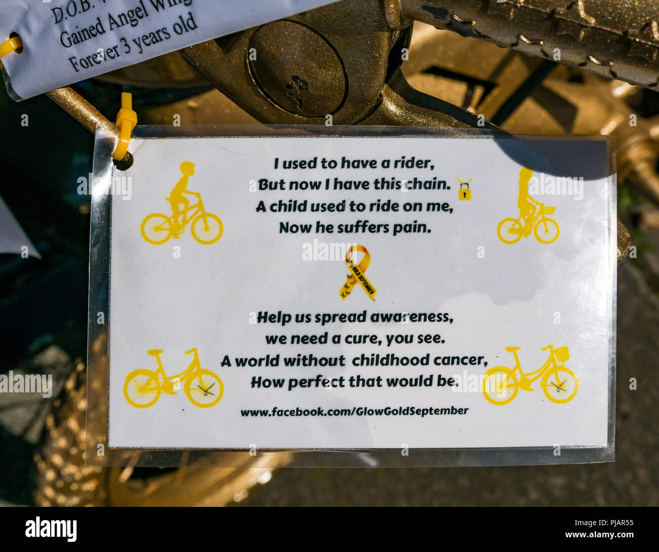 Message on gold painted child's bicycle, The Shore, Leith, Scotland, UK, Glow for Gold September campaign to raise awareness of childhood cancer Stock Photo