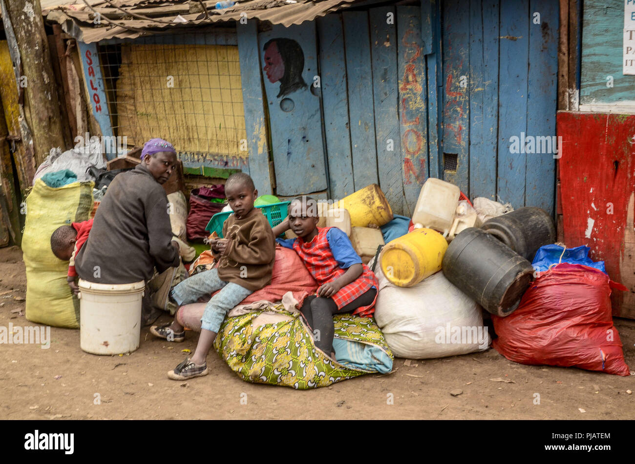 A family seen stranded with all its belongings during the demolition. Demolition by the government to create roads and ease the traffic congestion around Nairobi left over twenty thousand families homeless in Kibera Slums. The situation also affected some Private Nongovernmental Organizations and schools around the area. Stock Photo