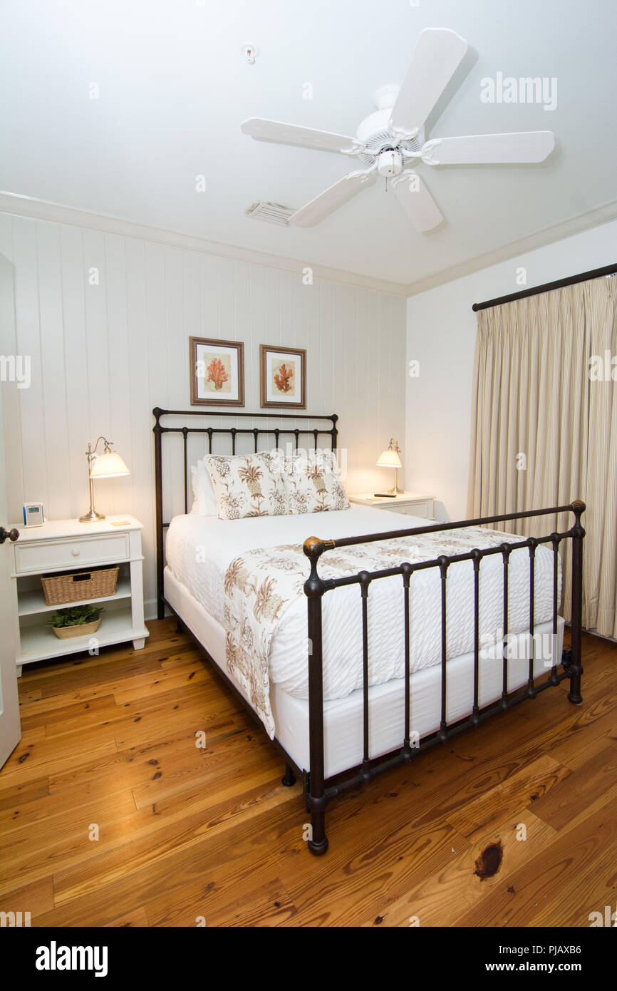 An interior shot of a bedroom with a ceiling fan Stock Photo