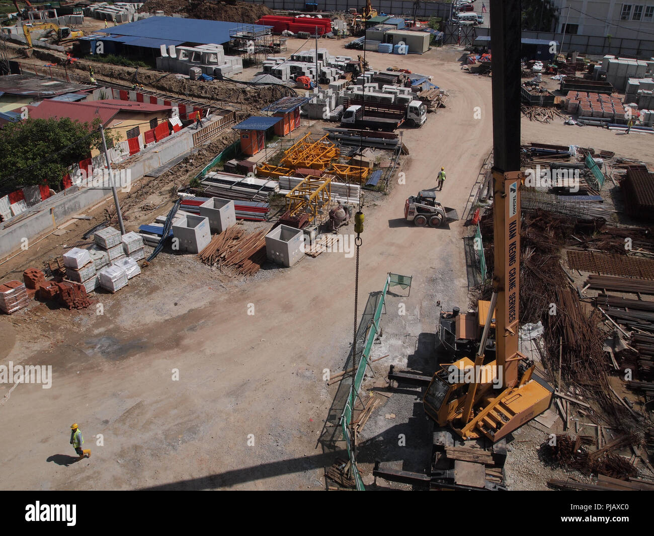 Construction site on progress at site. The construction of the building structure is still in its early stages. Earthwork work is also being done. Stock Photo