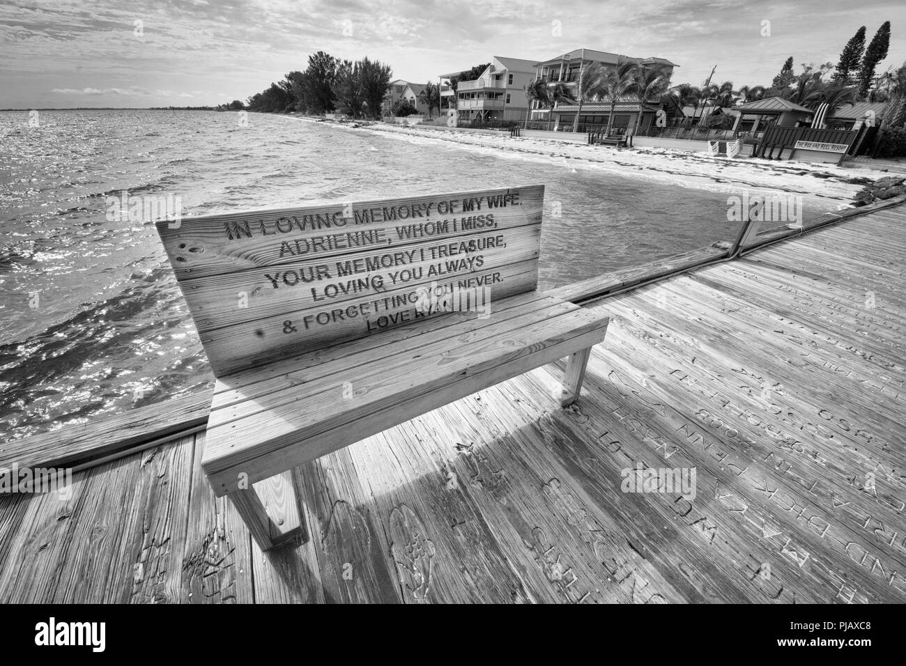 A memorial bench at the Rod and Reel Pier, a popular tourist attraction in picturesque Anna Maria Island, on the Gulf cost of Florida, USA Stock Photo