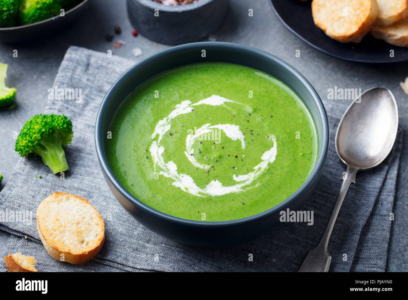 Broccoli cream soup in a bowl with toasted bread. Go green concept Stock Photo