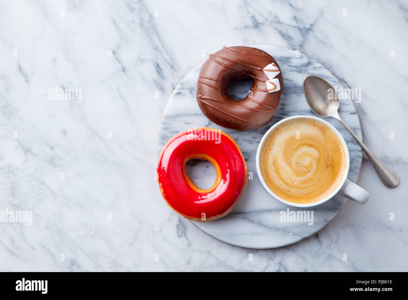 Coffee with donuts on marble table background. Copy space. Top view. Stock Photo