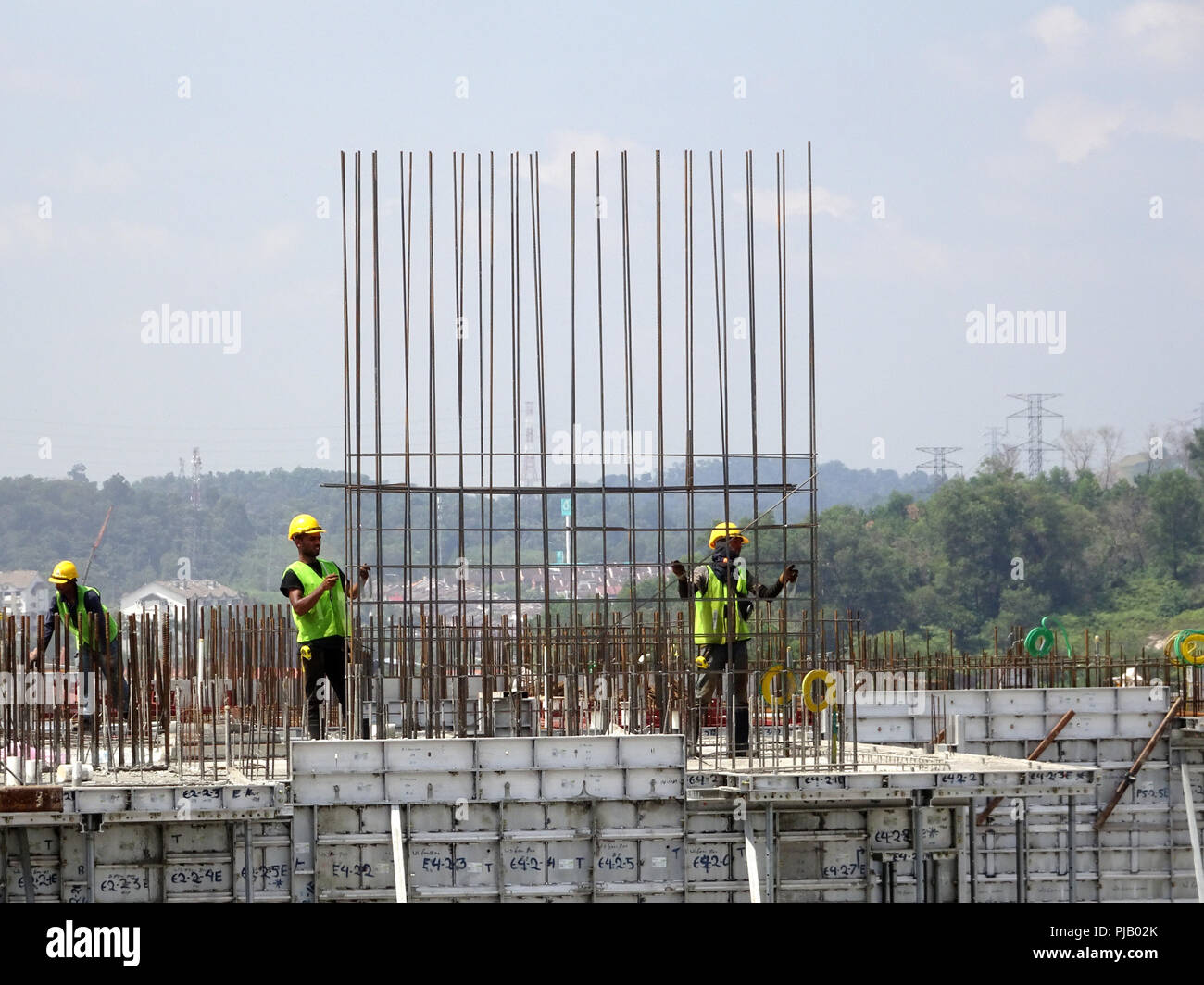 Construction workers installing reinforcement bar at the construction site. Reinforcement bar is the main component for the reinforcement concrete. Stock Photo