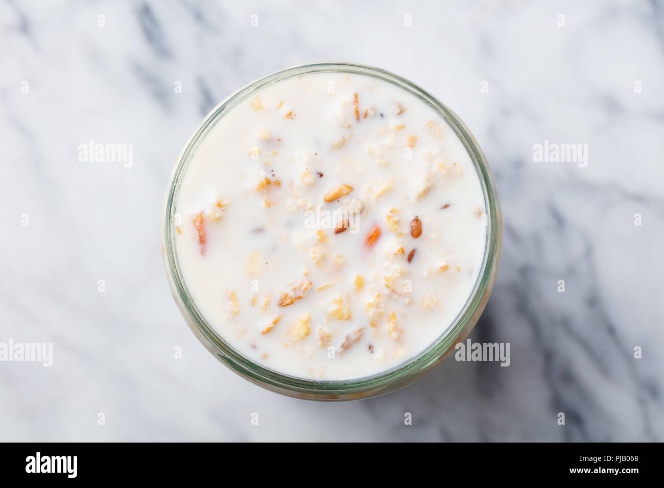 Overnight oats in glass jar on marble table. Top view Stock Photo Alamy