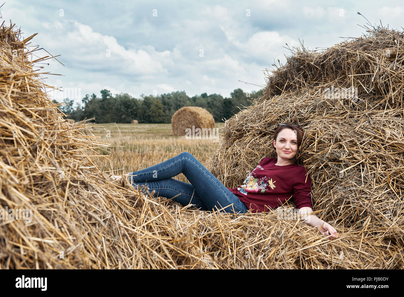 Girl lying on haystack hi-res stock photography and images - Alamy