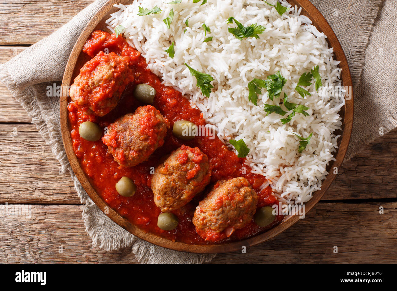 Traditional Greek meatballs in tomato sauce with rice closeup on a