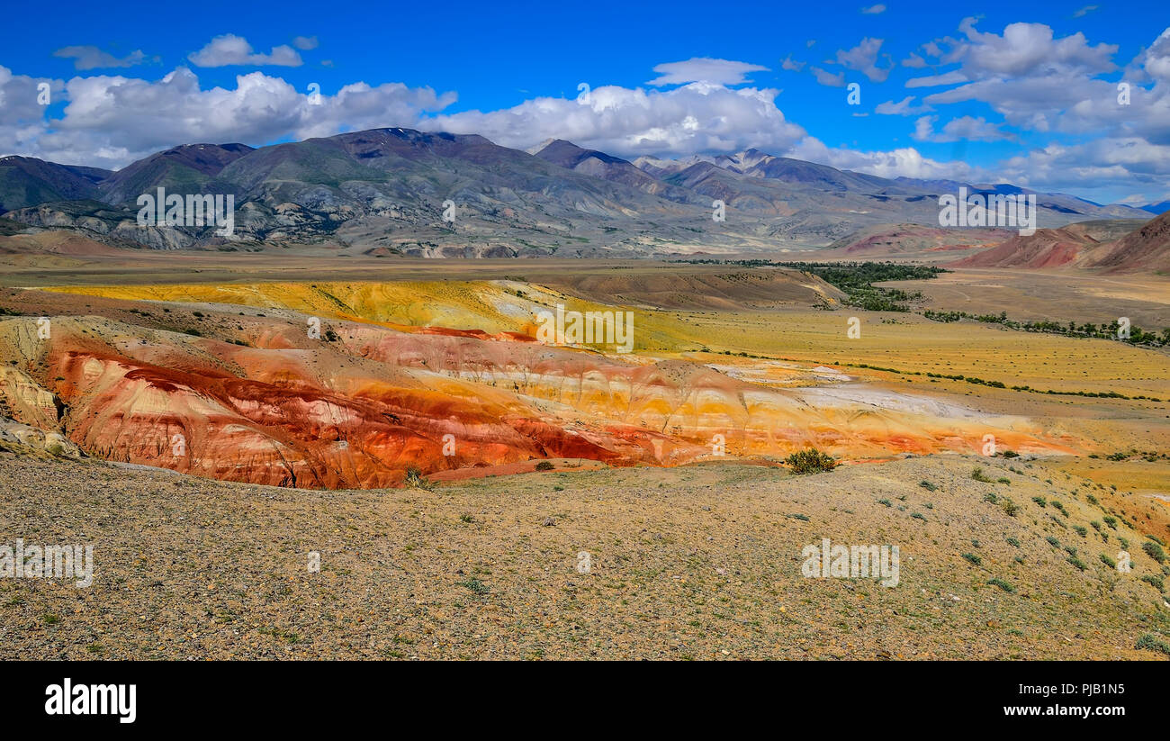 View of unrealy beautiful colorful clay cliffs in Kyzyl-Chin (Kisil-Chin) valley, Altai mountains, Russia. Summer landscape, which is called Martian f Stock Photo