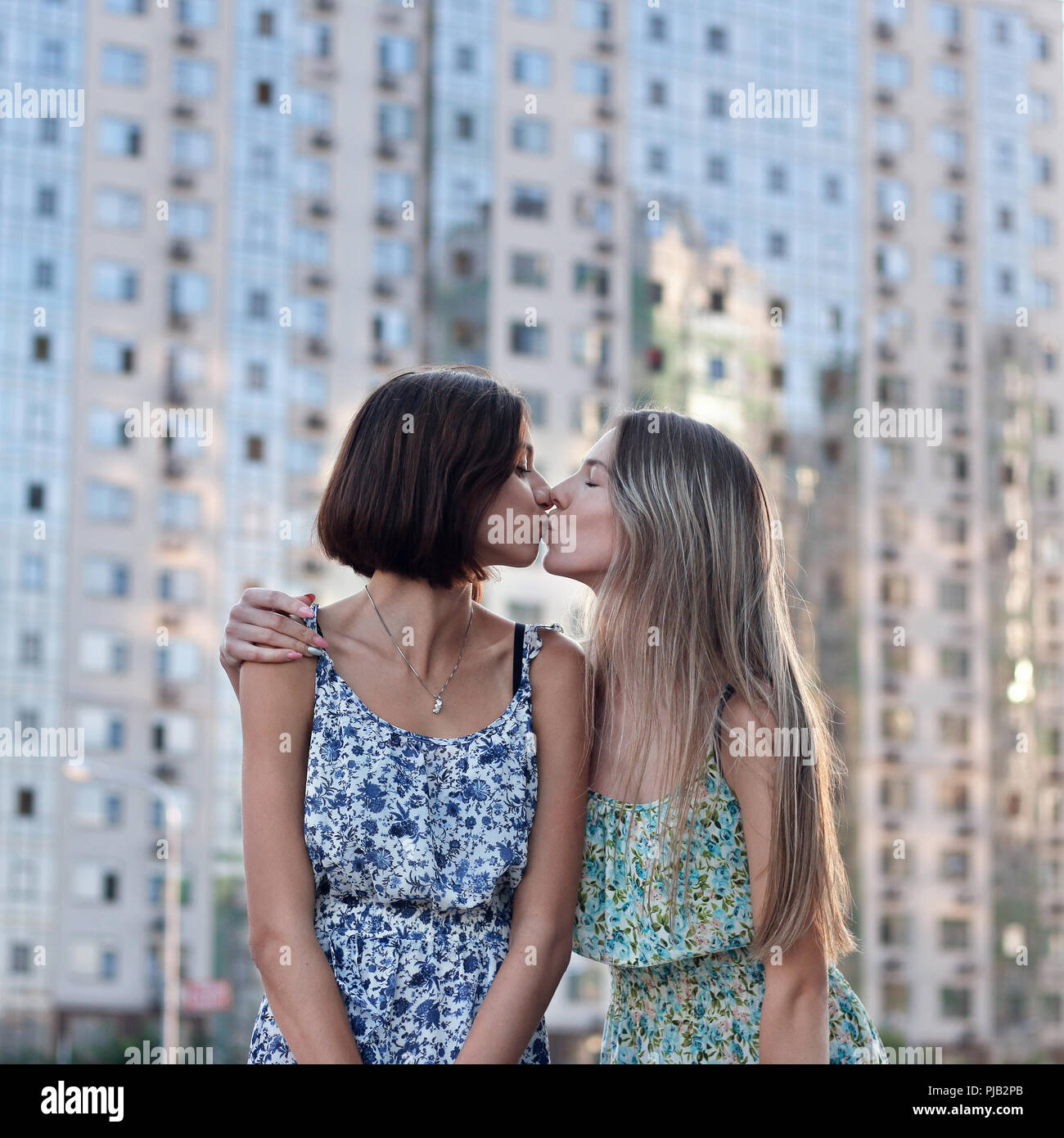two girls kissing each other in the street Stock Photo - Alamy
