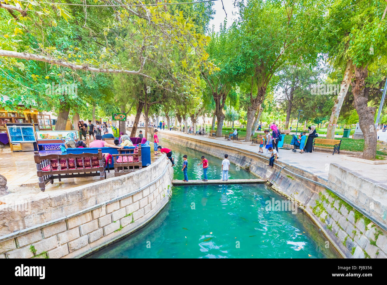 Unidentified people visit and explore Golbasi park in Sanliurfa,Turkey.18 July 2018 Stock Photo