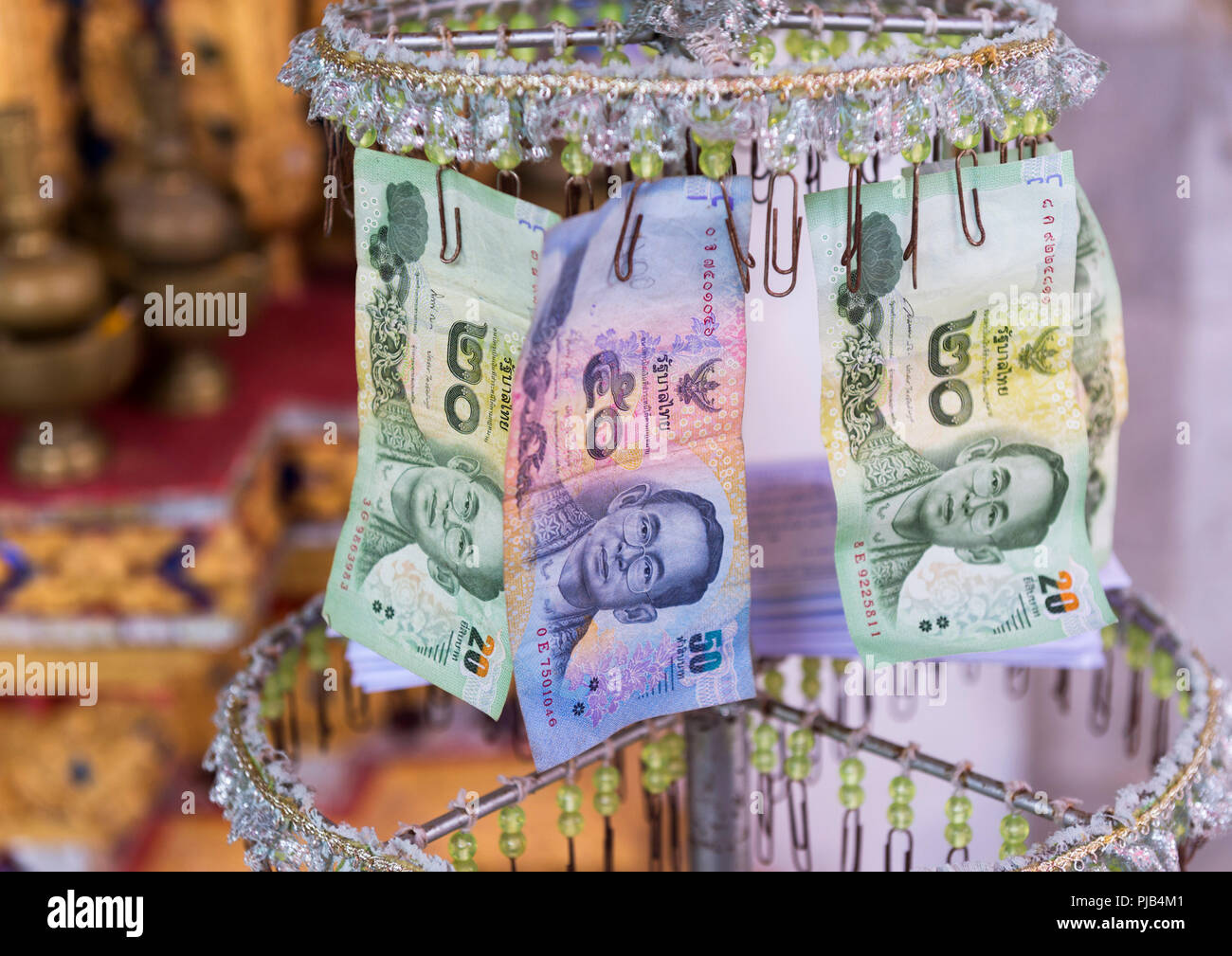 Wat Bang Riang Temple, That Put, Phang Nga Province, Thailand - Thai Banknotes given to the Monks at the temple Stock Photo