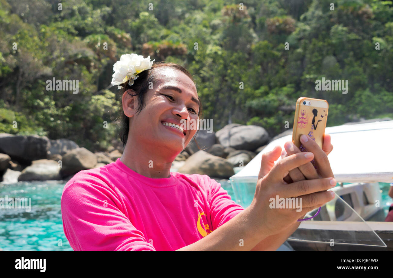 Lady Boy in bright Pink T Shirt taking a selfie Thailand Stock Photo