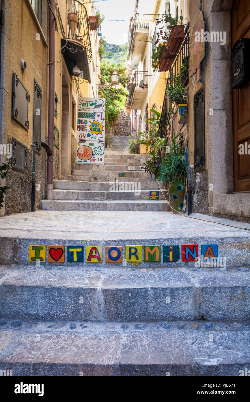 TAORMINA, ITALY - OCTOBER 16, 2014: Colorful write 'i love Taormina' written on the stairs with typical ceramic vases Trinacria. Beautiful detail of s Stock Photo