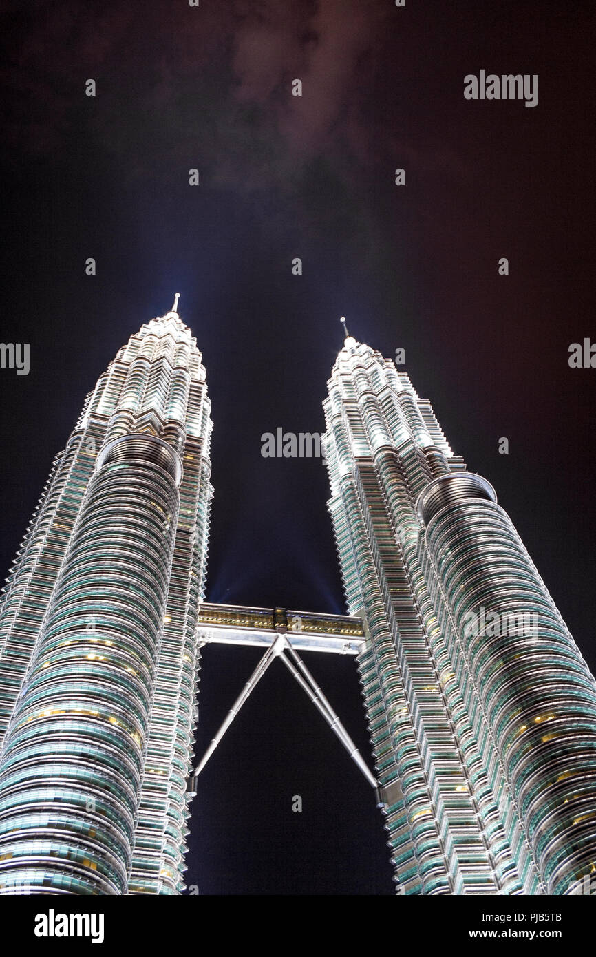 A low angle shot of the fully illuminated Petronas Twin Towers at night. Taken in December 2008 in Kuala Lumpur, Malaysia. Stock Photo