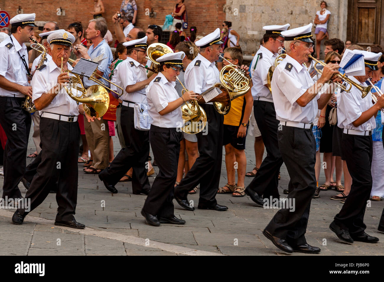 A Band Parades Through The Streets Of Siena Playing Music, The Palio di Siena, Siena, Italy Stock Photo