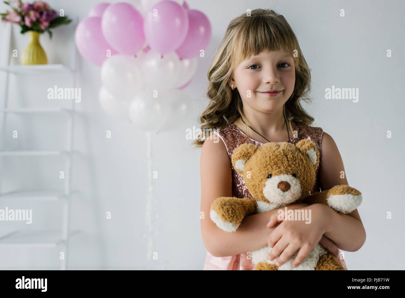 happy child looking at camera and embracing teddy bear Stock Photo - Alamy