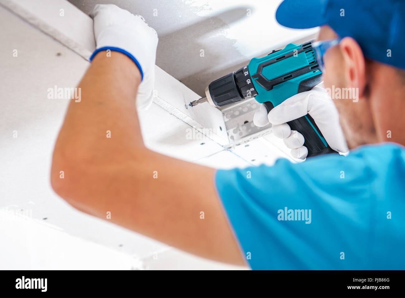 Drywall Ceiling Building By Caucasian Contractor With Power Tool
