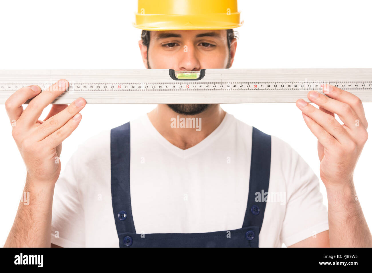 handsome construction worker in hard hat holding level tool isolated on white Stock Photo