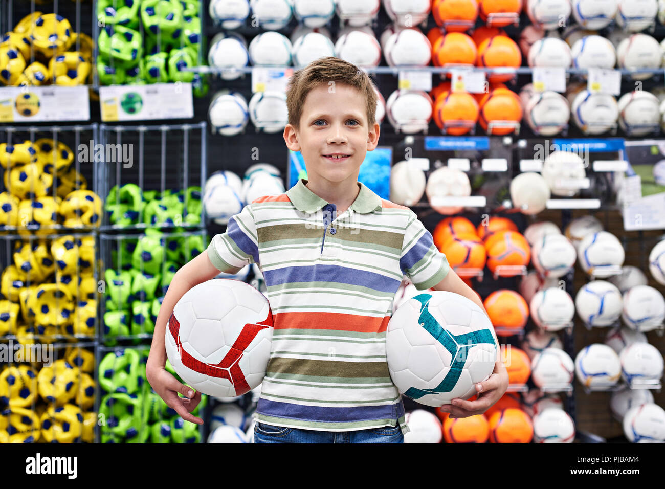 Boy with soccer balls in a sports store Stock Photo Alamy