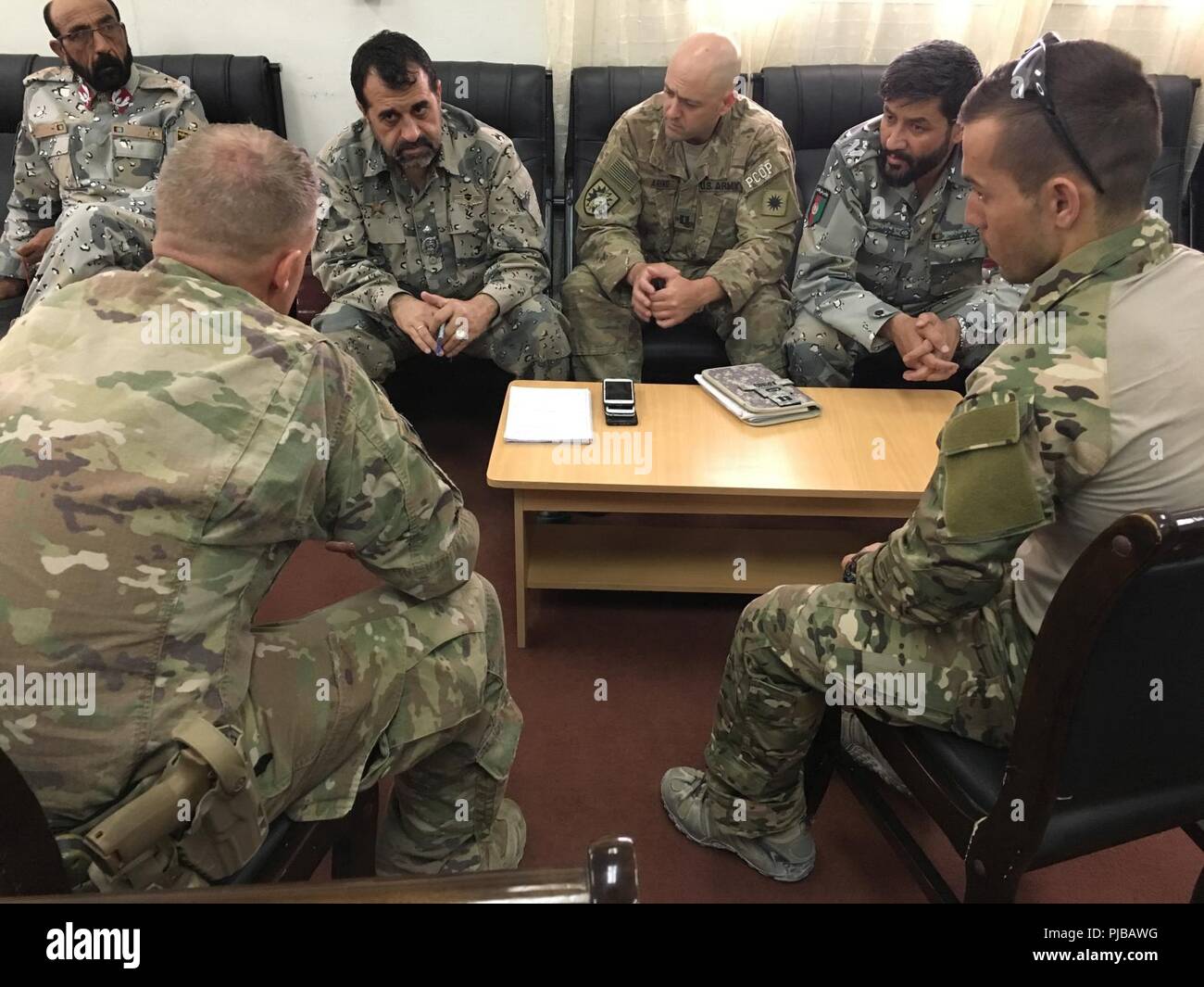 ZABUL PROVINCE, Afghanistan (July 02, 2018) -- Brig. Gen. Mirwais Noorzai, Provincial Chief of Police, Zabul province, along with two of his officers meet with advisors from the NATO-led Resolute Support Security Forces Assistance Brigade at the Afghan National Army 205th Corps, 2nd Brigade Headquarters. The Afghan National Army is working closely with the Afghan National Police in the Afghan-led offensive operations in the south. (NATO Stock Photo