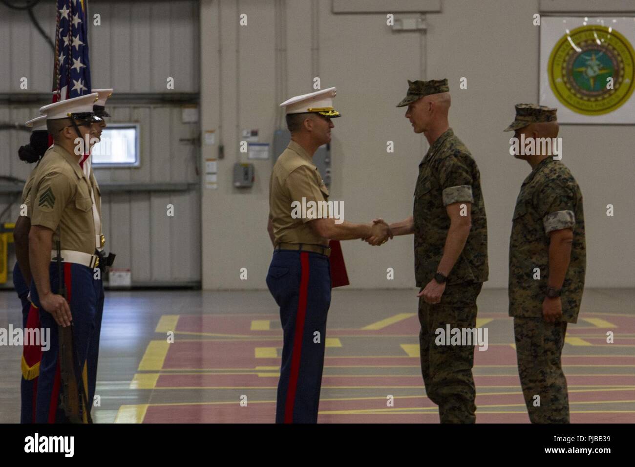 Brig. Gen. James F. Glynn, the commanding general of Eastern Recruiting Region, grants the Legion of Merit award to Col. Jeffrey C. Smitherman, the outgoing commanding officer of 6th Marine Corps District (MCD), during the awards portion of a change of command ceremony at Parris Island, South Carolina, July 2, 2018. During the ceremony, Smitherman relinquished his command to Col. William C. Gray. Stock Photo