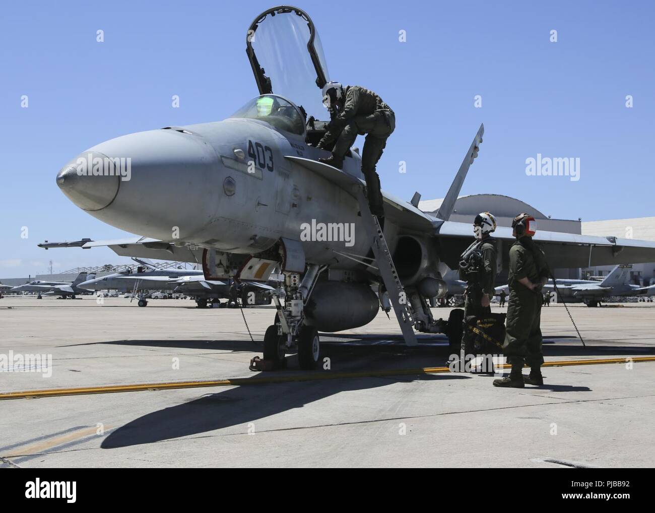 Maj. Gen. Mark R. Wise, the commanding general for 3rd Marine Aircraft Wing, climbs into an F/A-18C Hornet, during his final flight on Marine Corps Air Station Miramar, San Diego, Calif., July 02. Maj. Gen Wise flew for the last time as the commanding general of 3rd MAW. Stock Photo