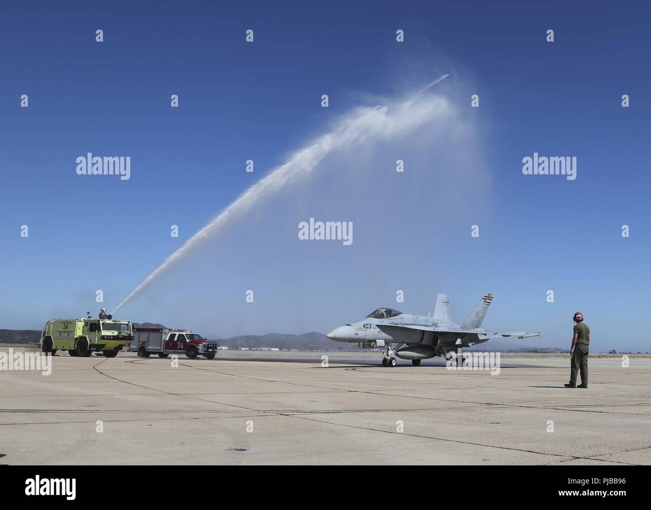 Maj. Gen. Mark R. Wise, the commanding general for 3rd Marine Aircraft Wing, is sprayed with water to celebrate his return from his final flight in an F/A-18C Hornet at Marine Corps Air Station Miramar, San Diego, Calif., July 02. Maj. Gen. Wise flew for the last time as the commanding general of 3rd MAW. Stock Photo